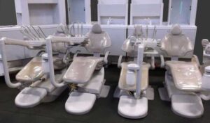 row of white dental chairs sitting in a showroom